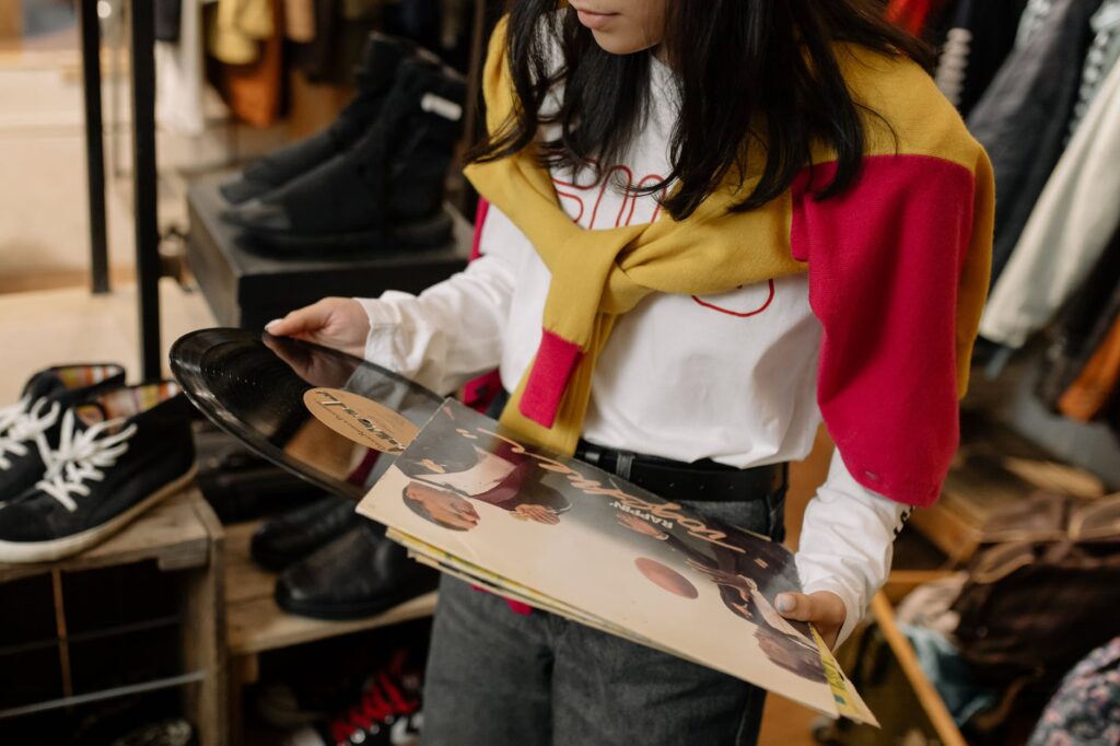 woman in white and red long sleeve shirt and blue denim jeans holding white and red