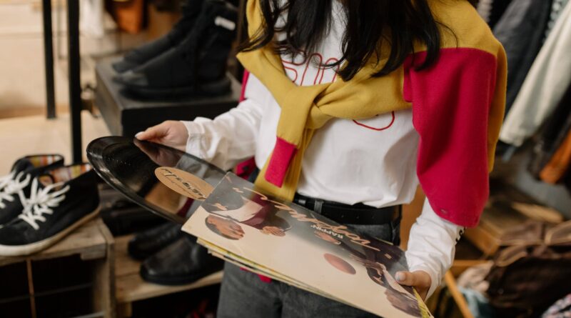 woman in white and red long sleeve shirt and blue denim jeans holding white and red