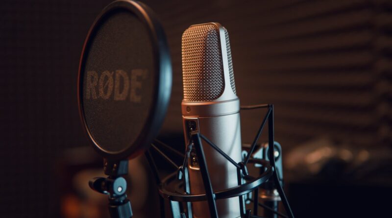 silver dynamic microphone on black microphone stand
