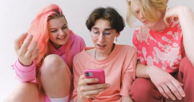 cheerful teenagers with smartphone looking at screen