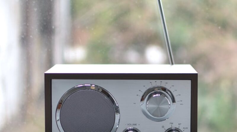 small retro radio set on wooden windowsill