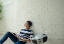 photo of man sitting near radio