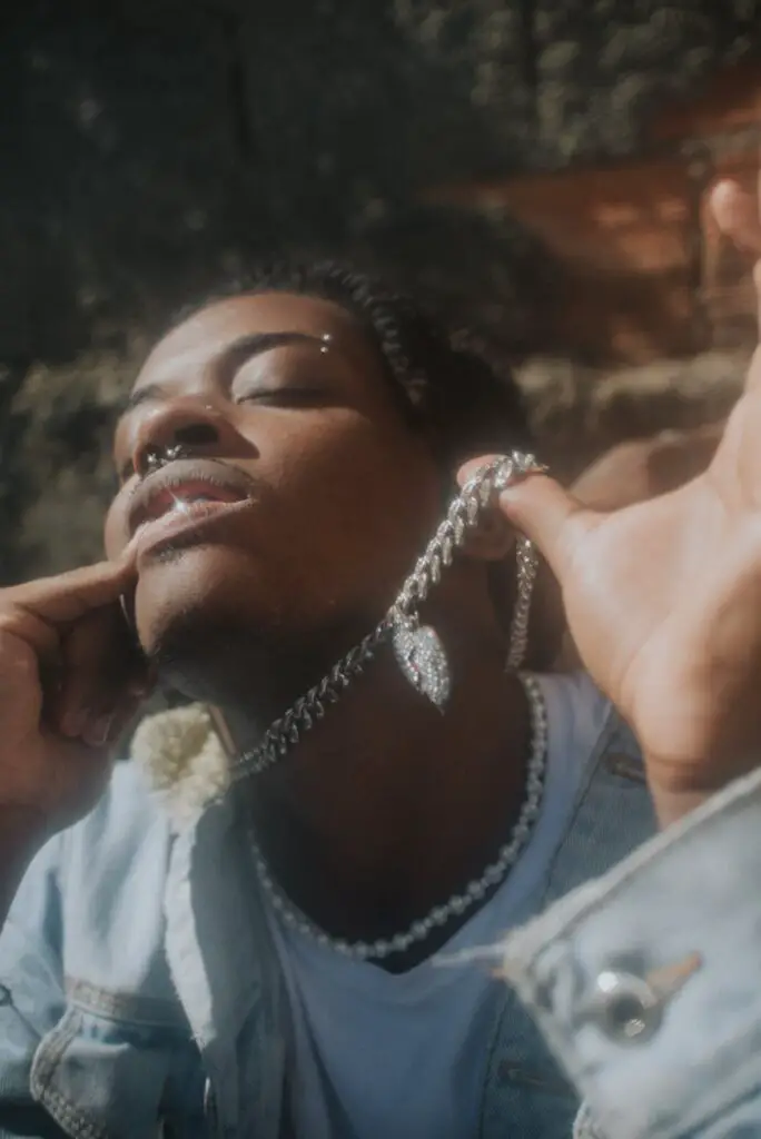 young man wearing chains and necklaces