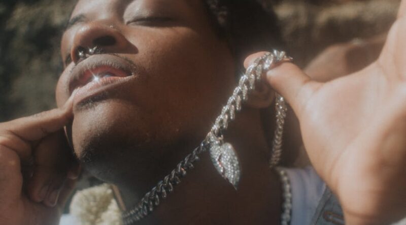 young man wearing chains and necklaces