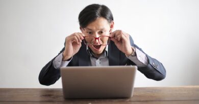 amazed formal male looking at laptop screen
