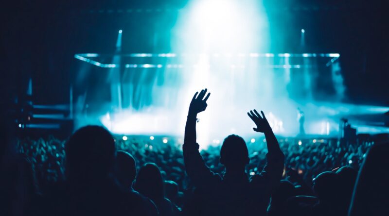 silhouette of people in front of stage