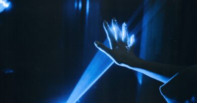 photo of person s hand with blue light