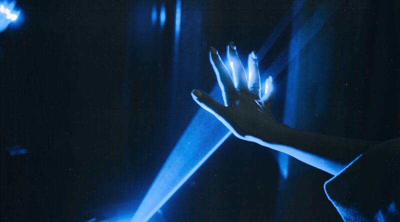 photo of person s hand with blue light