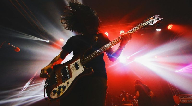 a man playing the guitar in a concert